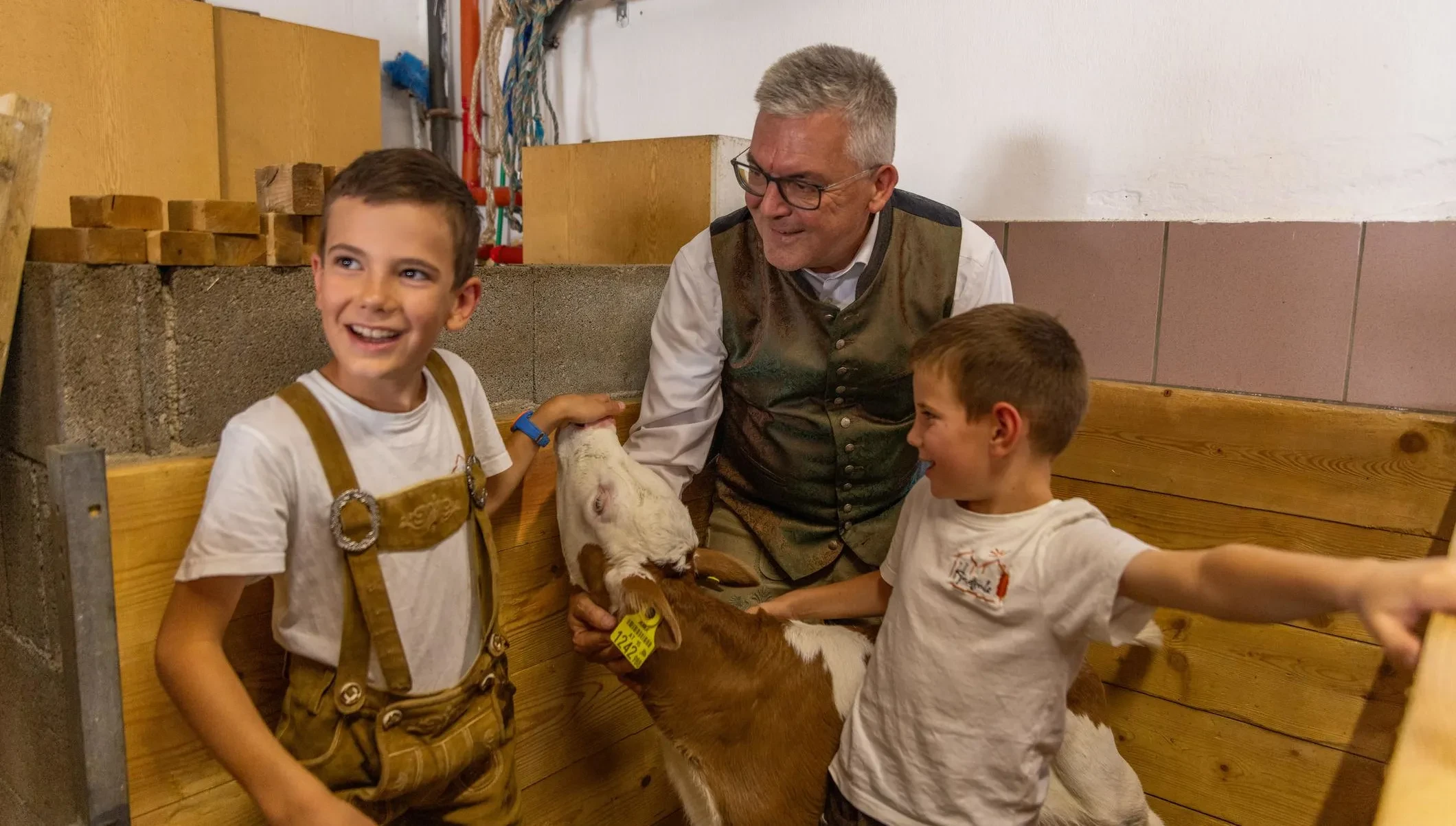 LR Schwaiger mit zwei Jungs vom Hundsalzhof im Stall